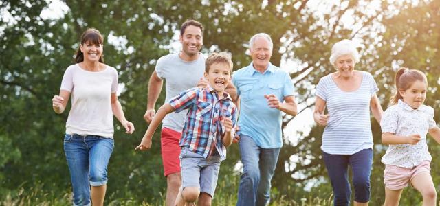 Multi-Generation Family Running Across Field Together